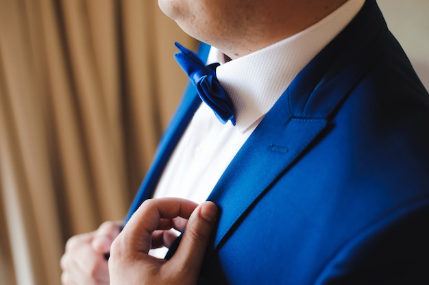 Wedding details - elegant groom dressed wedding tuxedo costume