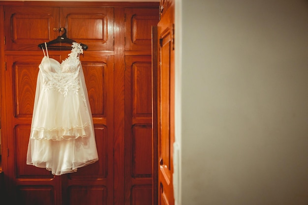 Wedding dress on wooden wall