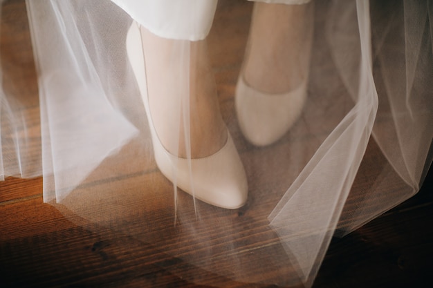 Wedding fashion shoes. Woman shoes on the bridal veil.