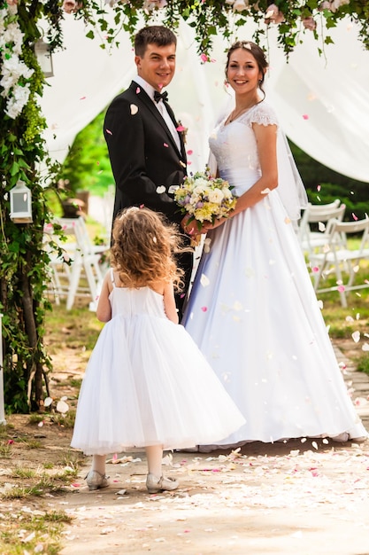 Wedding flying rose petals from kids at ceremony