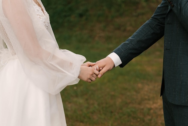 Wedding photo day The bride and groom hold hands