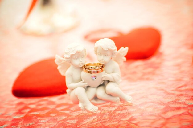 Wedding ring against small angels figure