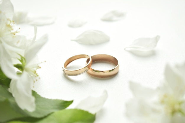 Wedding ring. On a white background and with delicate white flowers.