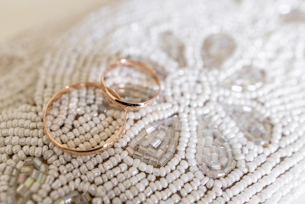 Wedding rings on a beaded table