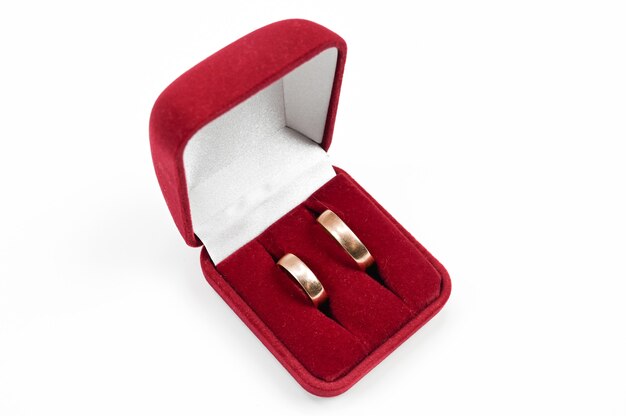 Wedding rings in a jewelry box, on an isolated white background . High quality photo