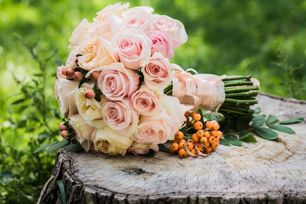 Wedding rings lie and beautiful bouquet