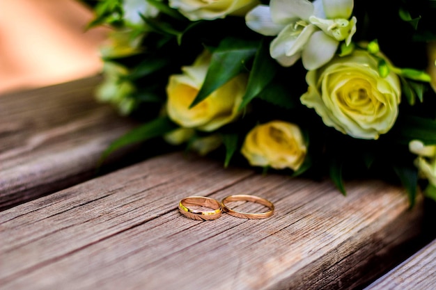 Wedding rings lie and beautiful bouquet