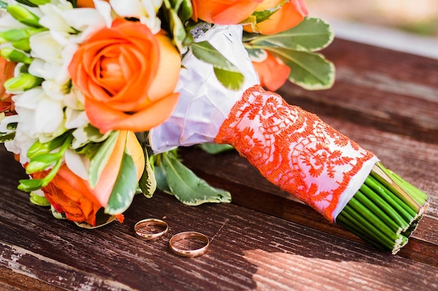 Wedding rings lie and beautiful bouquet