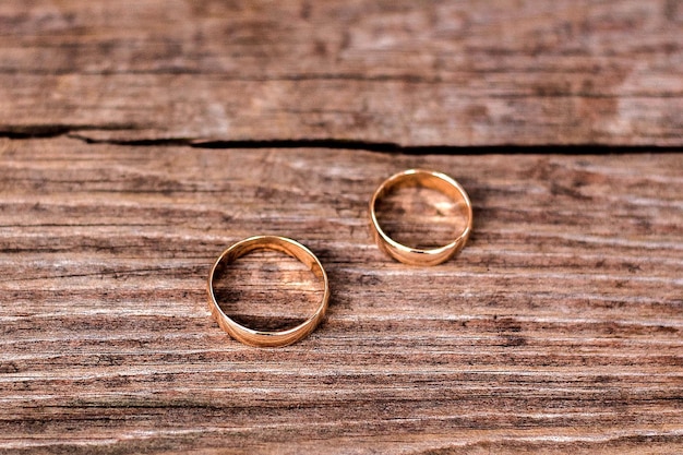 Wedding rings on a wooden background