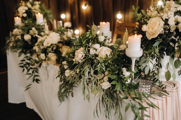 Wedding table decoration with flowers on the table, candlelit dinner table decor.