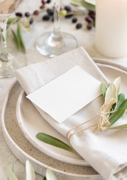 Photo wedding table place with card decorated with olive branches