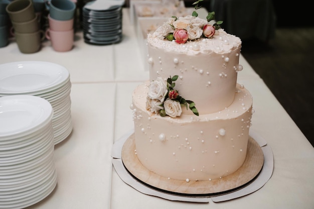 Wedding white cake with tiers decorated with rose flowers