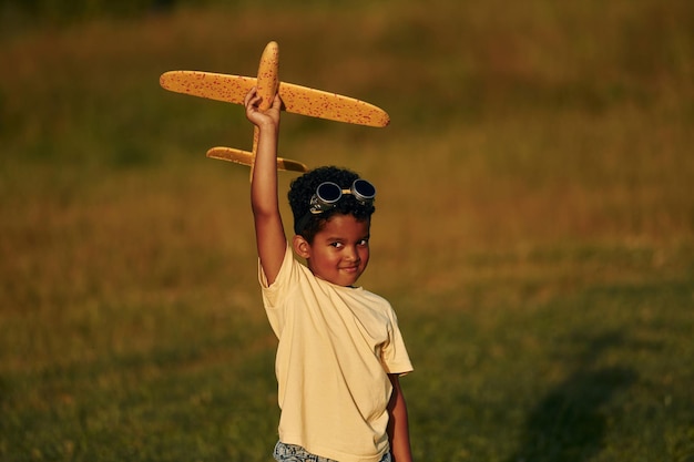 Weekend activities African american kid have fun in the field at summer daytime