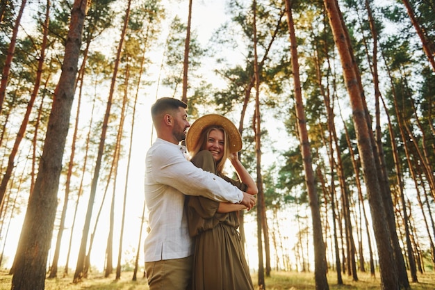 Weekend time spending Happy couple is outdoors in the forest at daytime