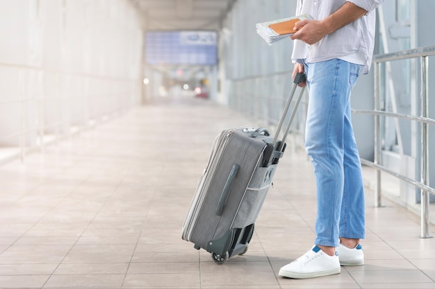 Weekend Trip Man With Passport Map And Suitcase Standing In Airport