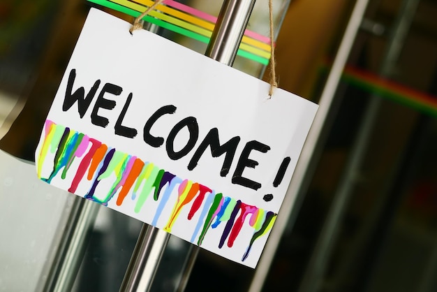 Welcome hand written text on paper hanging on cafe door