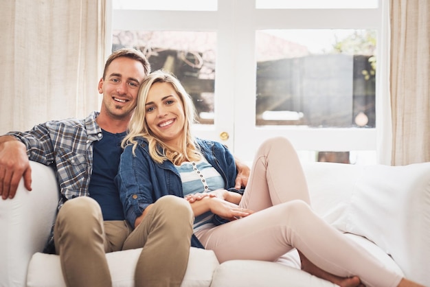 Welcome to our loving home Portrait of a young couple relaxing on the couch at home