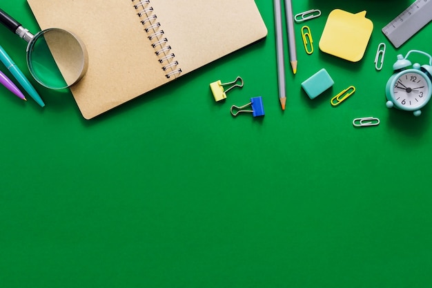 Welcome to school. Office supplies on a green school board. Various school supplies on a shabby green background. School sale concept