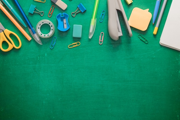 Welcome to school office supplies on a green school board various school supplies on a shabby green ...