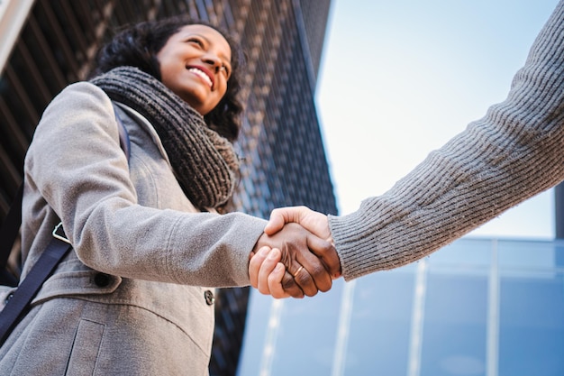 Welcoming business woman giving a handshake and smiling finishing successful meeting Greeting concept