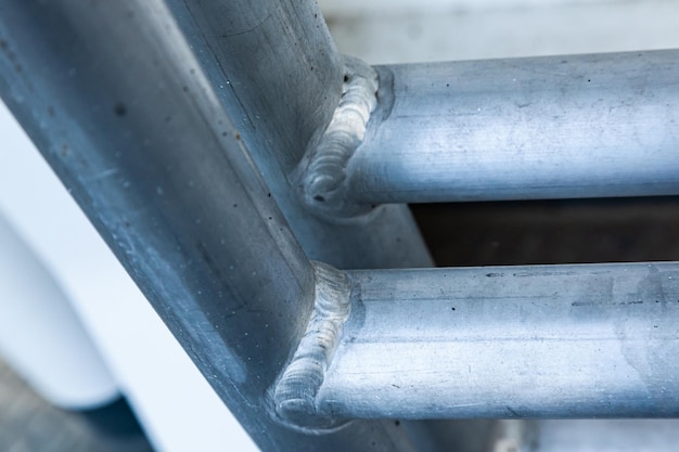 Welded aluminum pipes of a round profile closeup