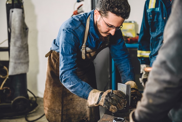 Welder checking angle of welded materials 