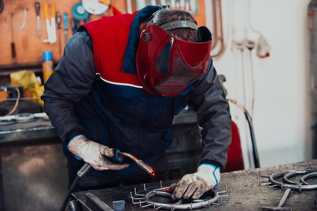 Photo welder erecting technical steel industrial steel welder in factory technical