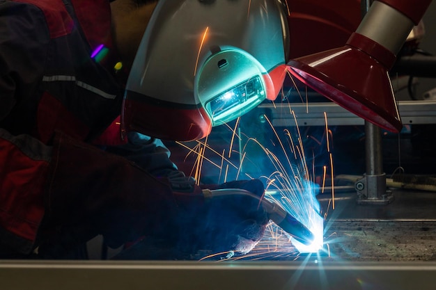 A welder erecting technical steel Industrial steel welder in factory technical