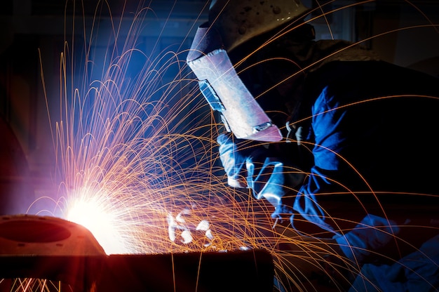 The welder is welding steel plates