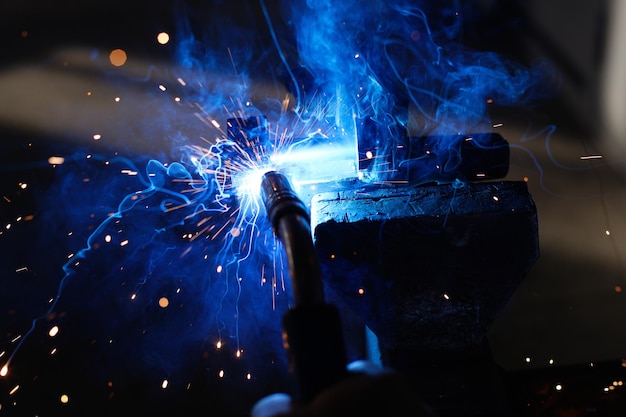 Welder's job Sparks from welding metal on a dark background