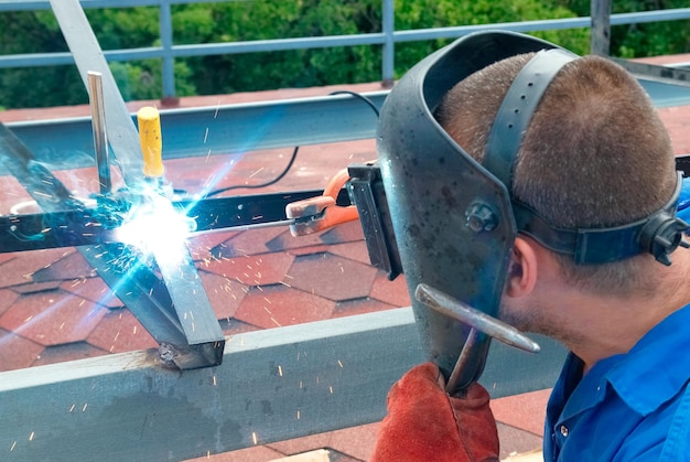 Welder working with metal construction