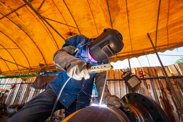 Welding male worker metal is part in machinery nozzle pipeline construction