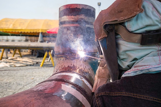 Welding male worker metal is part in machinery nozzle pipeline construction