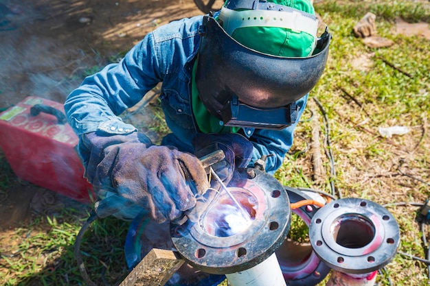 Welding male worker metal is part of warehouse machinery pipeline construction