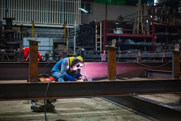 Welding male worker metal steel is part of beam structure