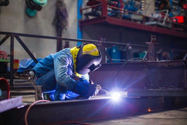 Welding male worker metal steel is part of beam structure