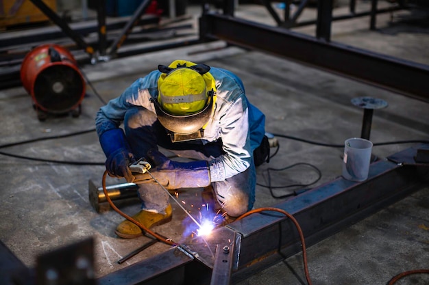 Welding male worker metal steel is part of beam structure