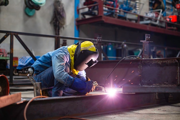 Welding male worker metal steel is part of beam structure