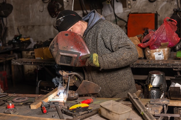 Welding process in the industrial workshop by worker