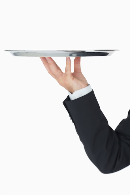 Well-dressed man holding silver tray