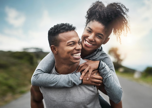 Well get theretogether Cropped shot of a handsome young sportsman piggybacking his athletic young girlfriend outside