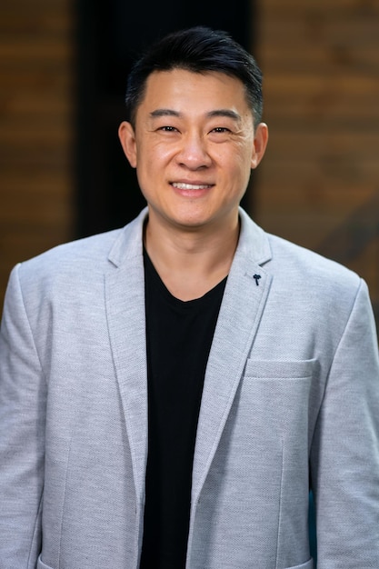 Welldressed young businessman smiling confidently while standing alone in a bright office