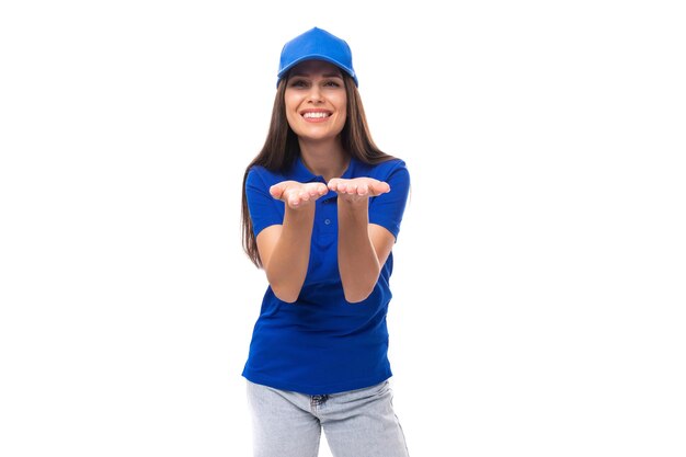 Wellgroomed pretty young caucasian brunette woman in uniform tshirt and cap with mockup for print