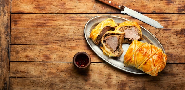 Wellington pork pork tenderloin baked with mushrooms in puff pastry