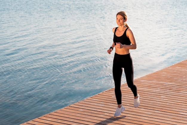 Wellness Concept Beautiful Middle Aged Female In Activewear Jogging Outdoors