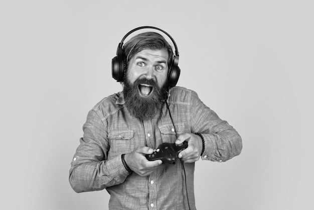 Went into a rage unshaven guy play computer games new technology in modern life online game concept of tv gaming bearded man gamer brutal hipster headphones with console hobby just have fun