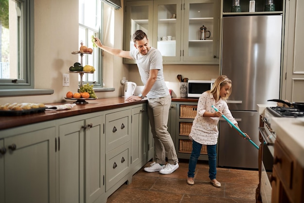 Were giving mom the day off Shot of a young man and his daughter cleaning the kitchen at home