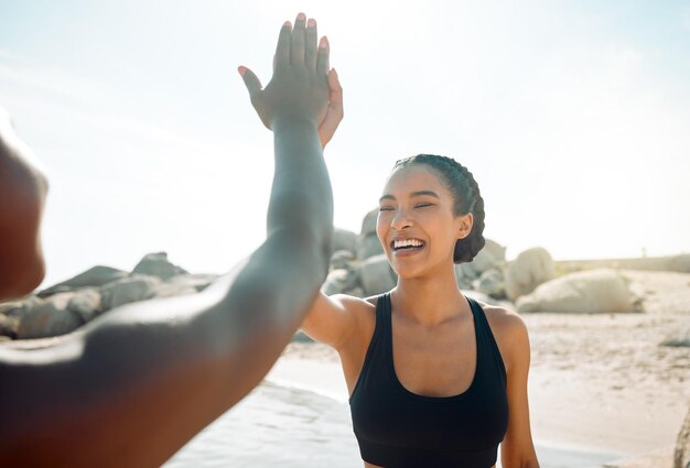 Were going to kick this workouts butt. Shot of two friends high fiving after a workout.