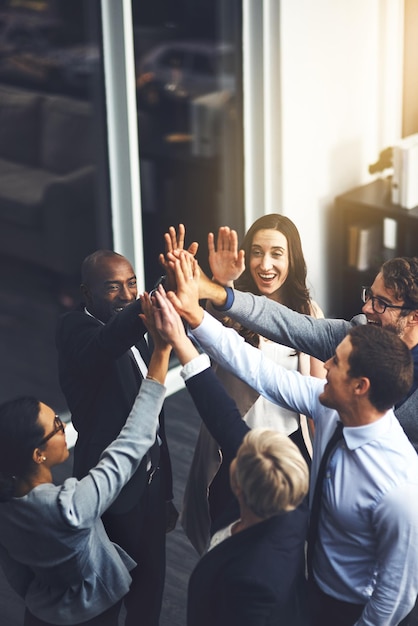 Were going to succeed no matter what Shot of a group of businesspeople high fiving in an office