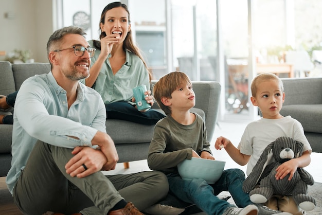 Were watching our favourite movie Shot of a young family watching tv together at home